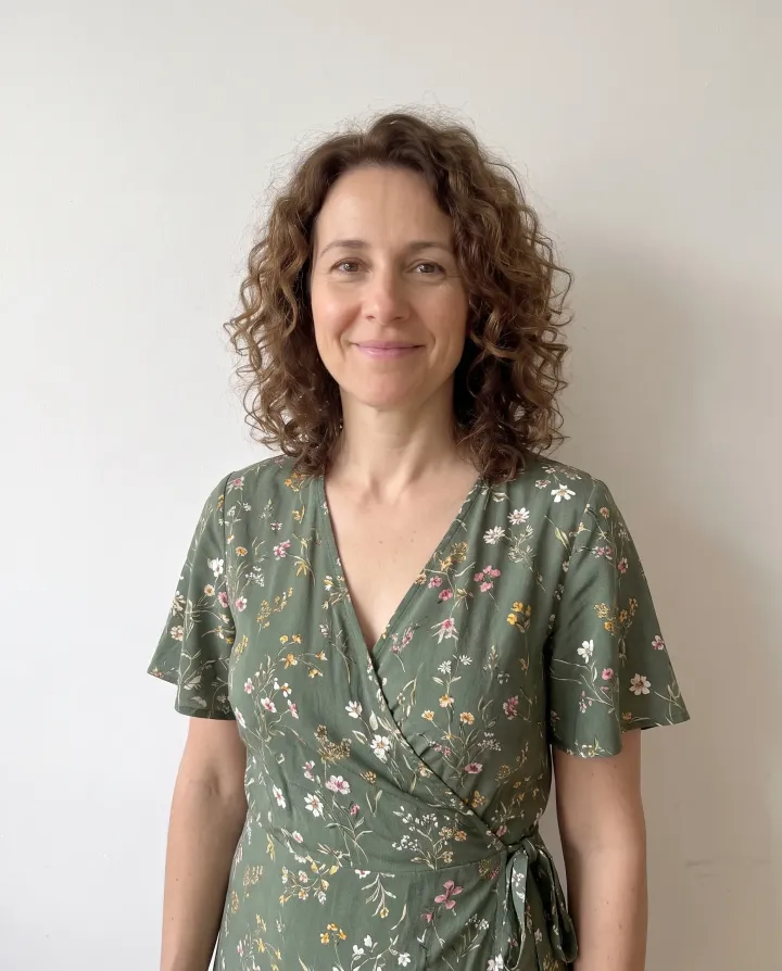 The same woman in a green floral wrap dress made from a written description