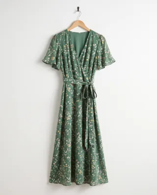 Product photo of a green floral wrap dress on a hanger