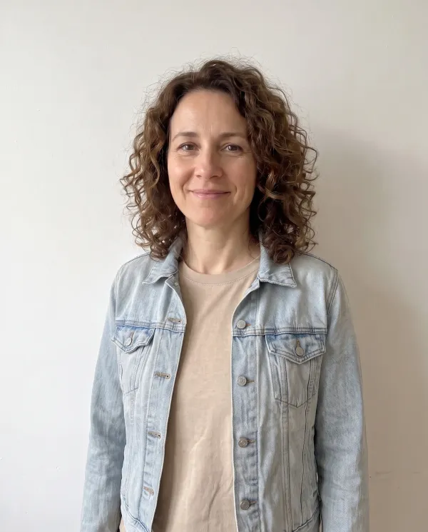 The woman wearing the light denim jacket from the flat lay photo