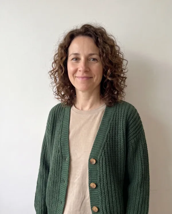 The woman wearing the green knit cardigan from the shop photo