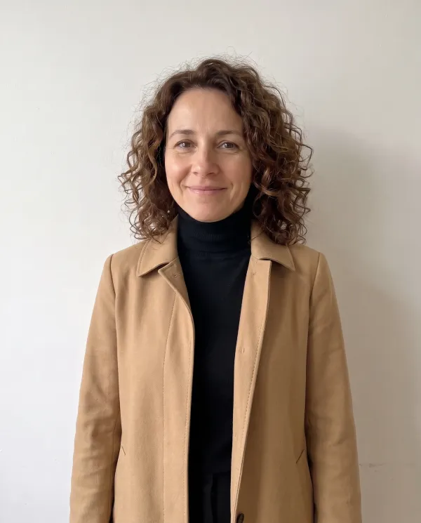 The woman in the camel trench coat and black turtleneck from the street photo