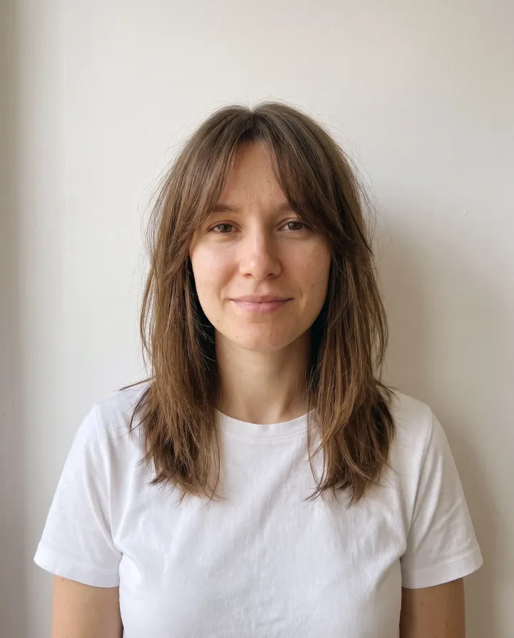 The woman with curtain bangs and long layers