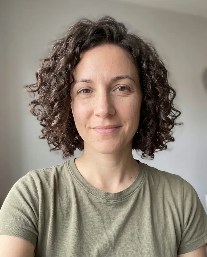 The same woman with a chin-length curly bob