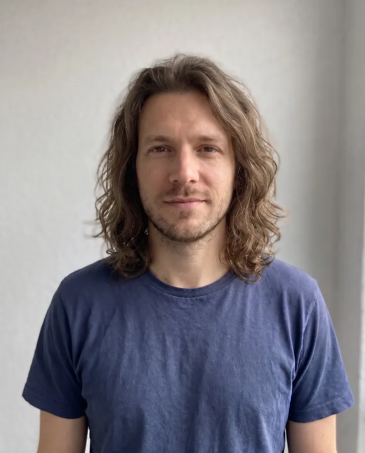 The man with shoulder-length wavy hair