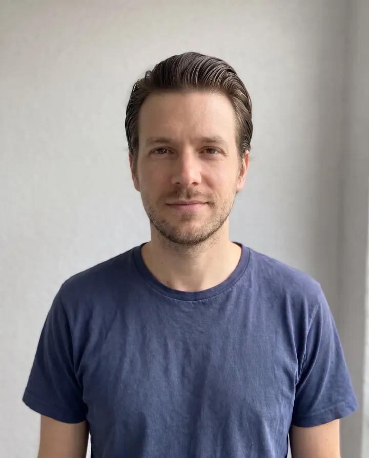 The man with slicked-back hair