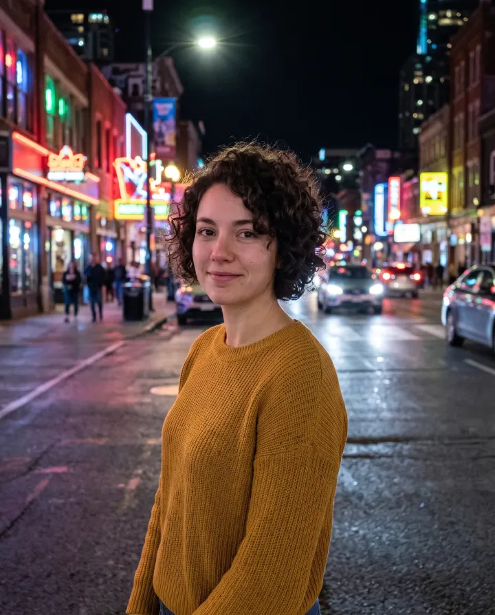 The woman on a city street at night lit by neon signs