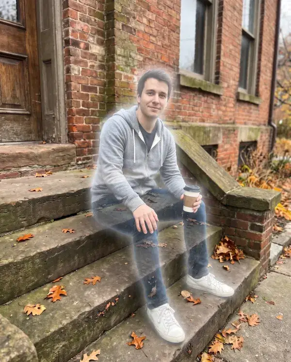 The same man on the brick steps turned half transparent with a soft glow