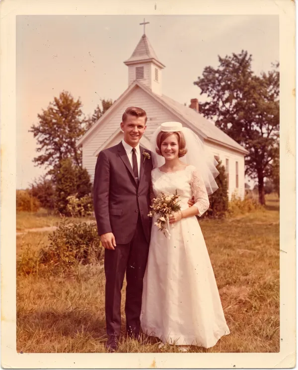A faded 1960s wedding photo with a strong orange and magenta color cast