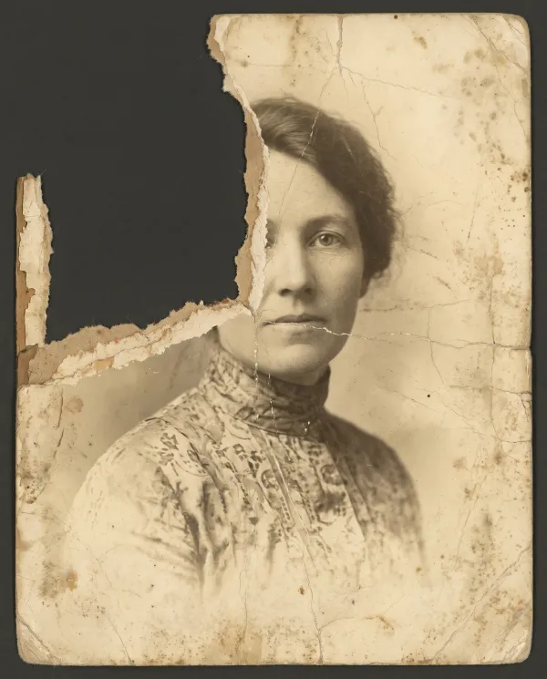 A 1920s sepia portrait of a woman with a large piece torn away across half her face