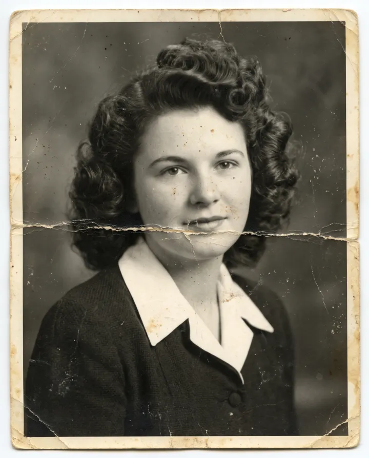 The damaged 1940s portrait with a crease and scratches